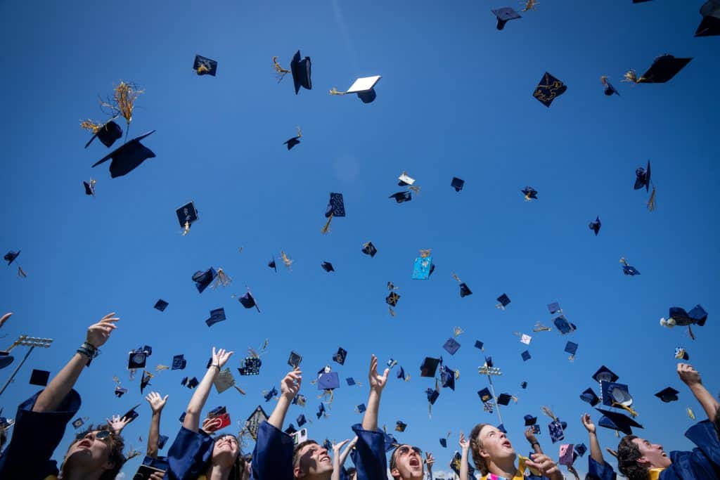 Frederick High School graduates toss their caps