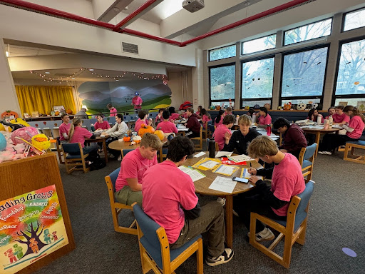 A group of SCLA students gather in the library to collaborate on a project.